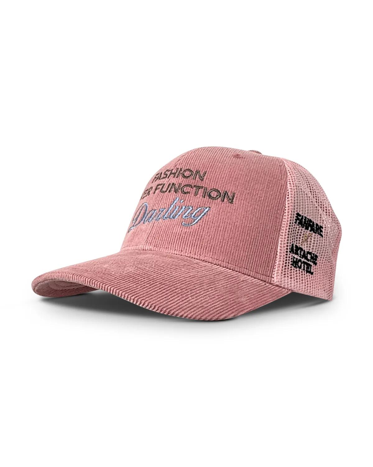 Pink corduroy trucker cap at a three quarter angle, showing the ribbed cord front, pink mesh back and side embroidery